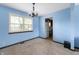 Inviting dining room featuring blue walls, natural light, and carpet flooring at 8306 Corkwood Dr, Indianapolis, IN 46227