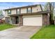 Exterior view of two-story home with attached garage and large driveway at 8306 Corkwood Dr, Indianapolis, IN 46227