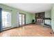 Bright living room featuring wood floors, a brick fireplace, and sliding door access to the backyard at 8306 Corkwood Dr, Indianapolis, IN 46227