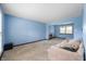 Spacious living room with a sitting area, soft blue walls, and bright natural light at 8306 Corkwood Dr, Indianapolis, IN 46227