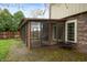 View of sunroom from the exterior and the brick patio at 8306 Corkwood Dr, Indianapolis, IN 46227
