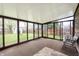 Enclosed sunroom with sliding glass doors provides natural light and access to the backyard at 8306 Corkwood Dr, Indianapolis, IN 46227