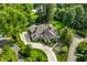 Stunning aerial view of a beautiful home with lush landscaping, a winding driveway, and a sparkling swimming pool at 8651 Emerald Ln, Indianapolis, IN 46260