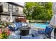 Serene backyard featuring a sparkling pool, comfortable patio furniture, and lush landscaping, ideal for outdoor enjoyment at 8651 Emerald Ln, Indianapolis, IN 46260