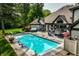 Gorgeous backyard with a swimming pool, hot tub, lounge chairs and an outdoor entertaining area at 8651 Emerald Ln, Indianapolis, IN 46260