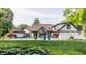 Expansive backyard featuring a pool, meticulously landscaped gardens, and a pristine lawn, ideal for outdoor activities at 8651 Emerald Ln, Indianapolis, IN 46260