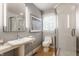 Bright bathroom features a glass shower, mosaic tile accents, and modern fixtures at 8651 Emerald Ln, Indianapolis, IN 46260
