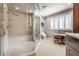 Bright bathroom with a walk-in shower, modern vanity, and ample natural light at 8651 Emerald Ln, Indianapolis, IN 46260