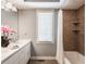 Well-lit bathroom with a double sink vanity, bathtub, and tiled shower at 8651 Emerald Ln, Indianapolis, IN 46260