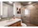 Cozy bathroom features a glass shower, vanity with a modern sink, and warm lighting at 8651 Emerald Ln, Indianapolis, IN 46260