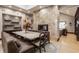 This dining room features a stunning fireplace, built-in shelving, and a cozy banquette seating at 8651 Emerald Ln, Indianapolis, IN 46260