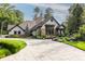 Inviting home showcasing manicured landscaping, stone accents, shingle siding and circular driveway at 8651 Emerald Ln, Indianapolis, IN 46260
