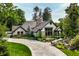 Charming home featuring stone and shingle exterior, lush landscaping, stamped driveway and inviting entrance at 8651 Emerald Ln, Indianapolis, IN 46260