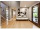 Bright foyer with hardwood floors, modern artwork and a view of the staircase at 8651 Emerald Ln, Indianapolis, IN 46260