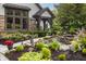 Gorgeous landscaping with vibrant flowers, stone pathway, and a charming entrance to the home at 8651 Emerald Ln, Indianapolis, IN 46260
