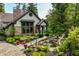 Beautiful backyard with mature trees, lovely landscaping, garden beds and charming water feature at 8651 Emerald Ln, Indianapolis, IN 46260