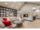 Comfortable living room featuring a modern fireplace, built-in shelving, and hardwood floors at 8651 Emerald Ln, Indianapolis, IN 46260