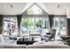 Living room with vaulted ceilings and large windows overlooking the pool and backyard at 8651 Emerald Ln, Indianapolis, IN 46260