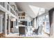 Open-concept living room with vaulted ceilings, natural light, and a view of the upper level at 8651 Emerald Ln, Indianapolis, IN 46260