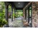 Inviting outdoor patio with stone columns, lush greenery, and an elegant entertaining space at 8651 Emerald Ln, Indianapolis, IN 46260