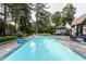 Resort-style backyard with pool, hot tub, patio, lounge chairs, and lush landscaping at 8651 Emerald Ln, Indianapolis, IN 46260