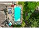 Detailed aerial shot of a pristine backyard pool, complete with a cozy lounge area and a hot tub at 8651 Emerald Ln, Indianapolis, IN 46260