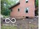 Side exterior view shows siding damage near the foundation of the home at 8803 S Sleepy Hollow Rd, Waldron, IN 46182