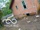 Shows the side of a house with weathered siding and a basement crawlspace at 8803 S Sleepy Hollow Rd, Waldron, IN 46182