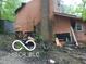 Damaged exterior with chimney, siding issues, and exposed foundation at 8803 S Sleepy Hollow Rd, Waldron, IN 46182