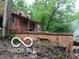 Shows damage between the house and a retaining wall at 8803 S Sleepy Hollow Rd, Waldron, IN 46182