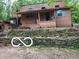 Exterior elevation with weathered siding, stone wall, and covered porch at 8803 S Sleepy Hollow Rd, Waldron, IN 46182
