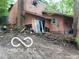 Exterior featuring a sliding door, damaged siding, and surrounding debris at 8803 S Sleepy Hollow Rd, Waldron, IN 46182