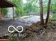 Exterior shot showing damage between the house and detached garage structure at 8803 S Sleepy Hollow Rd, Waldron, IN 46182