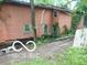 Image of an older two-story house with a boarded-up basement window and wood siding at 8803 S Sleepy Hollow Rd, Waldron, IN 46182