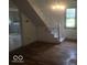 Living room features hardwood floors, neutral paint, and a staircase at 9024 W Mooresville Rd, Indianapolis, IN 46113