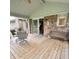 Outdoor deck space with chairs, a sliding door entrance, and a view of the backyard at 907 Corey Ln, Plainfield, IN 46168