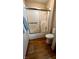 A well-lit bathroom showing a shower-tub with sliding doors and a standard white toilet at 907 Corey Ln, Plainfield, IN 46168