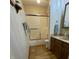 Bright bathroom featuring a shower-tub with sliding doors and a vanity with wooden cabinets at 907 Corey Ln, Plainfield, IN 46168