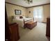 Cozy bedroom with soft bedding, a window with sheer curtains, and classic wood furniture at 907 Corey Ln, Plainfield, IN 46168