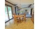 Cozy dining area with wooden table and chairs, sliding glass doors, and open access to the living room at 907 Corey Ln, Plainfield, IN 46168