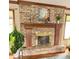 Cozy brick fireplace with wooden mantel and decorative accents in a well-lit living space at 907 Corey Ln, Plainfield, IN 46168