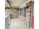 Covered front porch with brick wall, front door, and outdoor plants at 907 Corey Ln, Plainfield, IN 46168