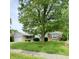 Charming one-story home featuring a well-maintained front yard and a mature tree at 907 Corey Ln, Plainfield, IN 46168