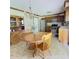Kitchen featuring oak cabinets, stainless steel appliances, and an adjacent wooden dining table at 907 Corey Ln, Plainfield, IN 46168