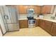 Charming kitchen with stainless steel appliances, oak cabinetry, and a modern refrigerator at 907 Corey Ln, Plainfield, IN 46168