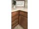 Close-up of kitchen cabinets with countertops and decorative 'Home' sign and small potted plant at 907 Corey Ln, Plainfield, IN 46168