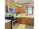 Well-maintained kitchen with stainless steel appliances, wood cabinets, and bright countertops at 907 Corey Ln, Plainfield, IN 46168