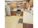 Well-lit kitchen with oak cabinetry, stainless steel appliances, and bright countertops at 907 Corey Ln, Plainfield, IN 46168
