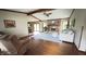 Spacious living room with a brick fireplace, beamed ceilings, hardwood floors, and cozy seating at 907 Corey Ln, Plainfield, IN 46168