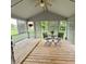 Relaxing screened porch with wooden floors, lattice screens, and outdoor seating at 907 Corey Ln, Plainfield, IN 46168